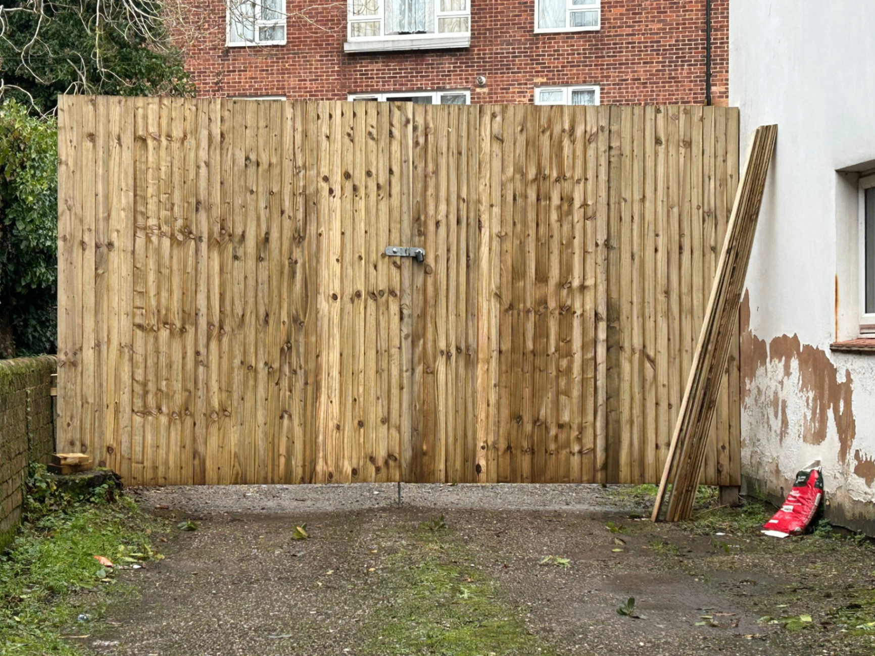Tall timber gate with steel lock plate installed by AJW Carpentry on an Exeter property