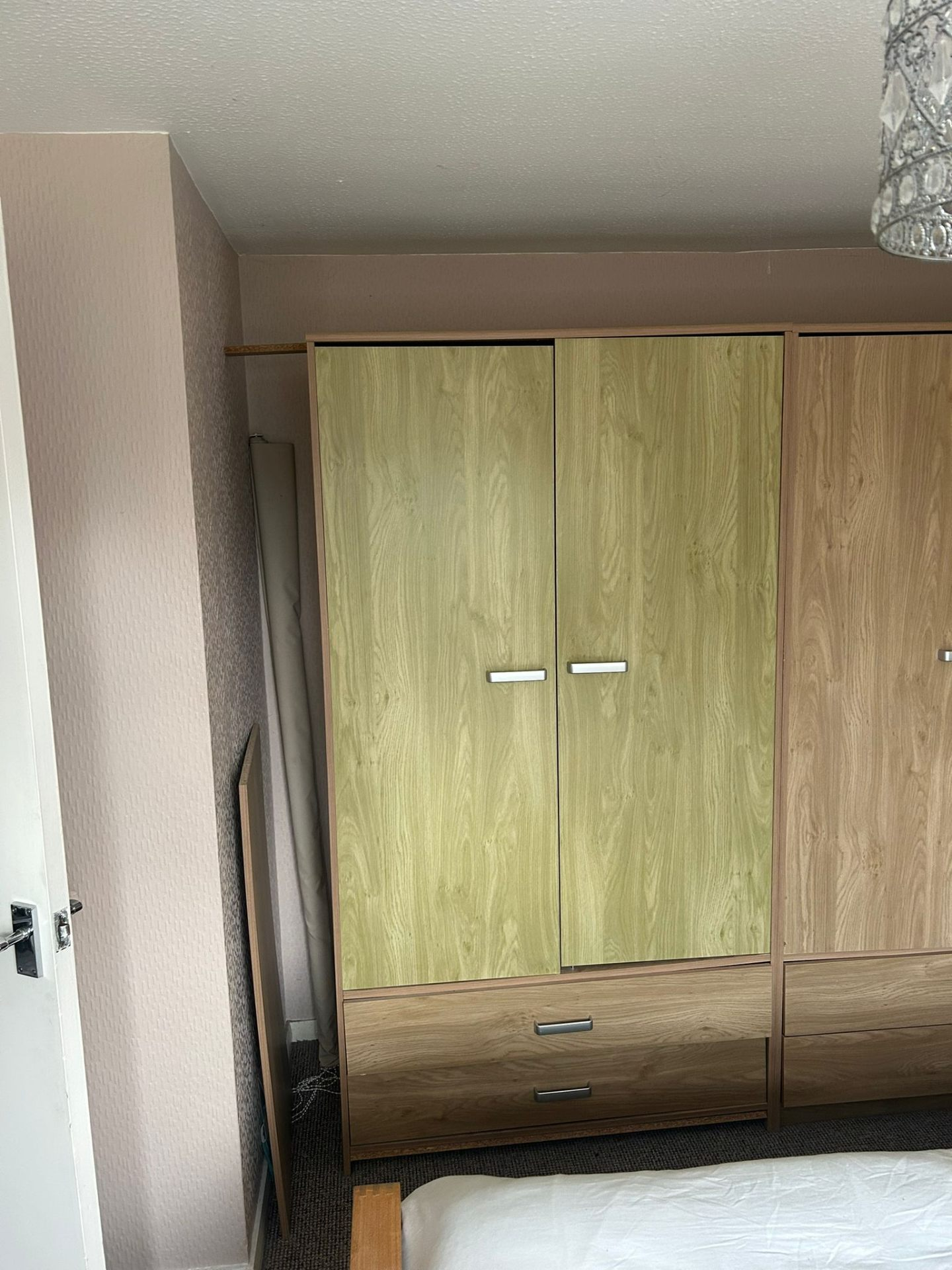 Old mismatched wardrobe doors in a Sidmouth bedroom before AJW Carpentry refit
