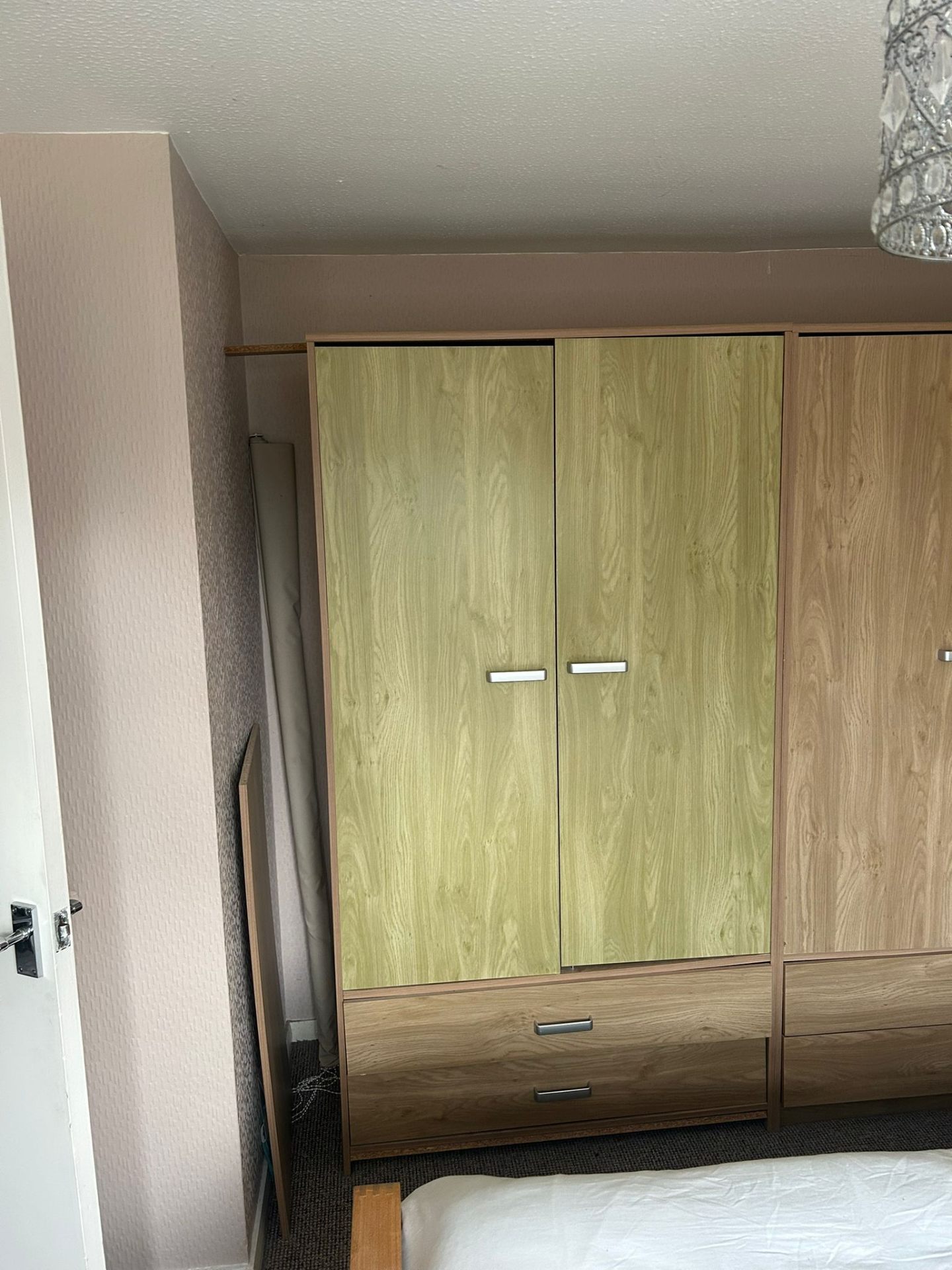 Bespoke fitted bedroom storage with light timber wardrobe and drawers in East Devon
